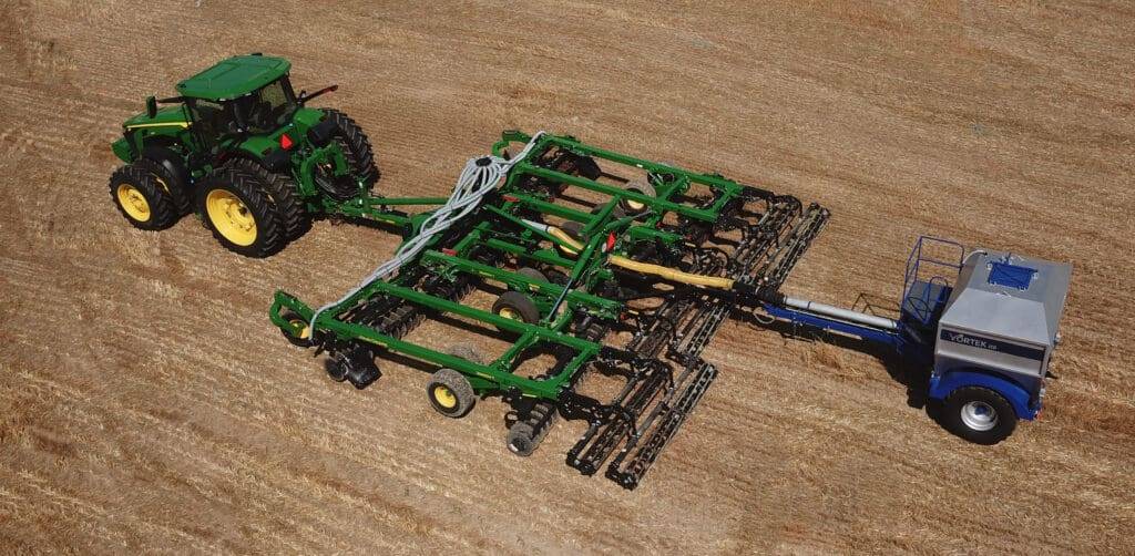 John Deere tractor in field pulling Vortek Air Seeder